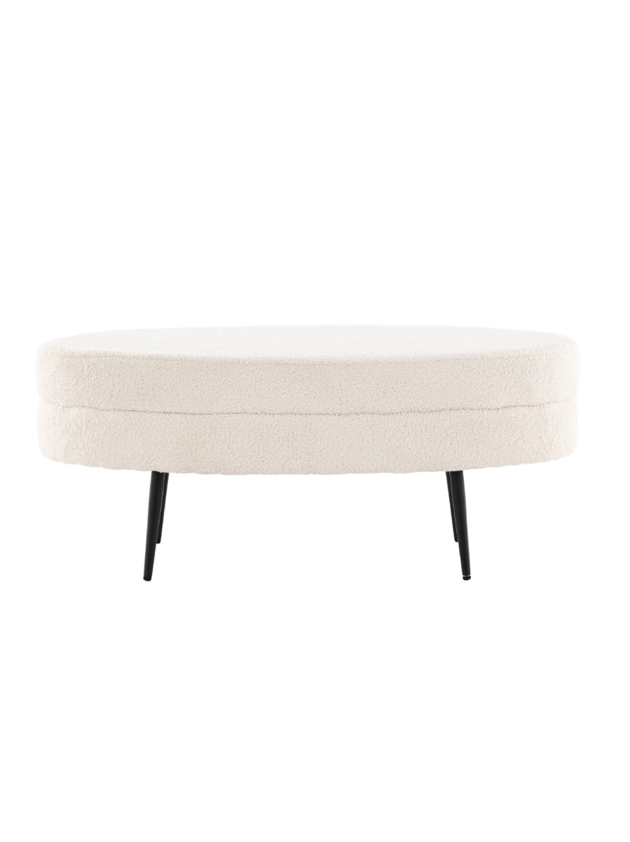 Oval sittpuff i vitt teddytyg med svart metallstomme i modernt hem