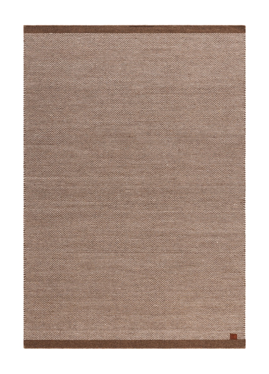 Handvävd mörklinne ullmatta i varm nyans på golv