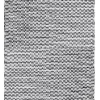 Svart mjuk trasmatta i bomull med ca 10 mm tjocklek liggande på golv i ett inrett rum