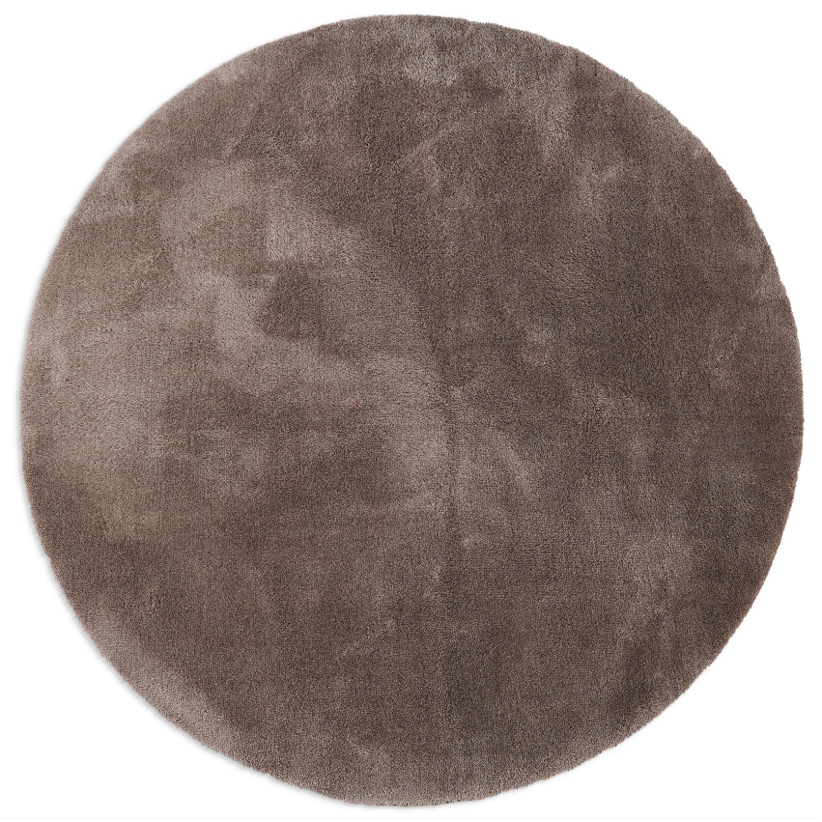 Rund taupefärgad fluffig ryamatta med tjock mjuk yta i hemmiljö