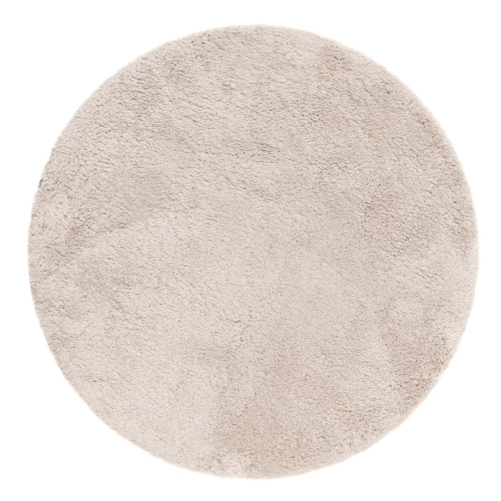Rund ryamatta i greige färg med tjock och mjuk lugg på trägolv