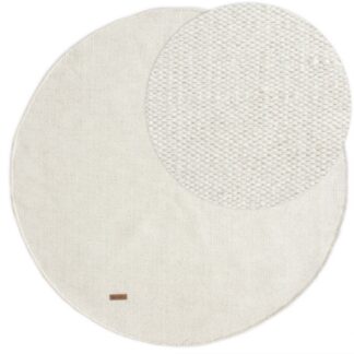 Rund ullmatta i offwhite med mjuk och tjock textur placerad på golv i modernt rum