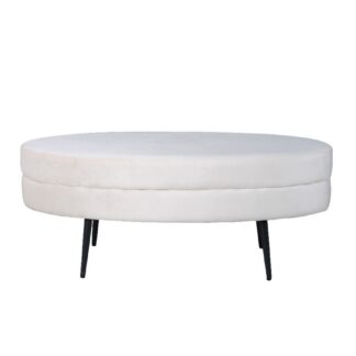 Vit oval sittpuff i sammetstyg med svarta metallben i modern inredningsmiljö