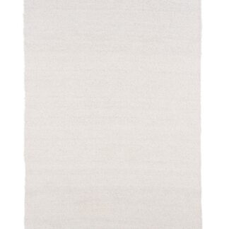 Vit mjuk ullmatta med cirka 20 mm tjocklek som skapar en varm och elegant atmosfär i rummet