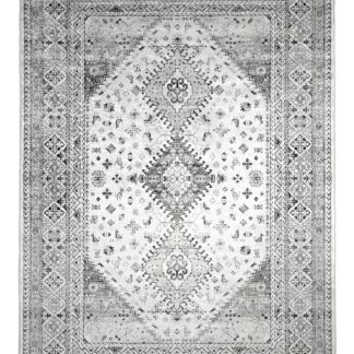 Lyra Grå ryamatta i mjuk polypropylen med tjock lugg på vit bakgrund