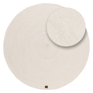 Rund cremefärgad ullmatta med tvinnat mönster i vardagsrum