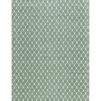 Grön handvävd plastmatta med bomullsvarp i mjuk PVC liggande på golv