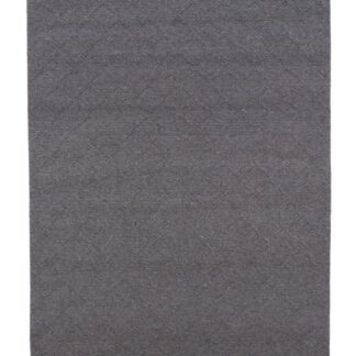 Grå ullmatta med tjock, mjuk textur i naturligt heminteriör