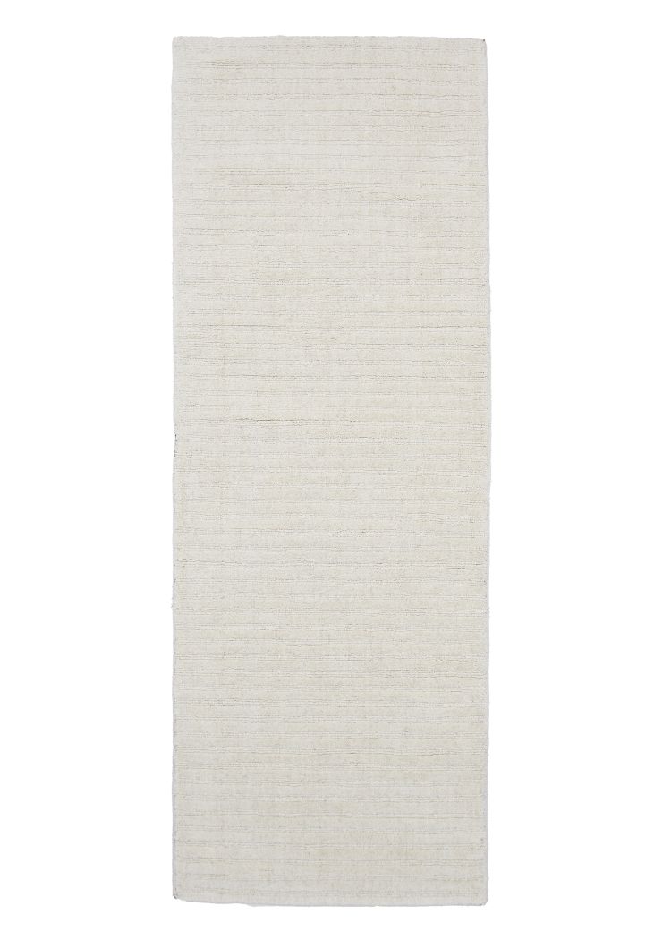 Vit ullmatta med låg lugg och ribbad yta i modernt vardagsrum