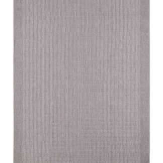 Costa grå flatvävd matta i polypropylen placerad inomhus på ett trägolv