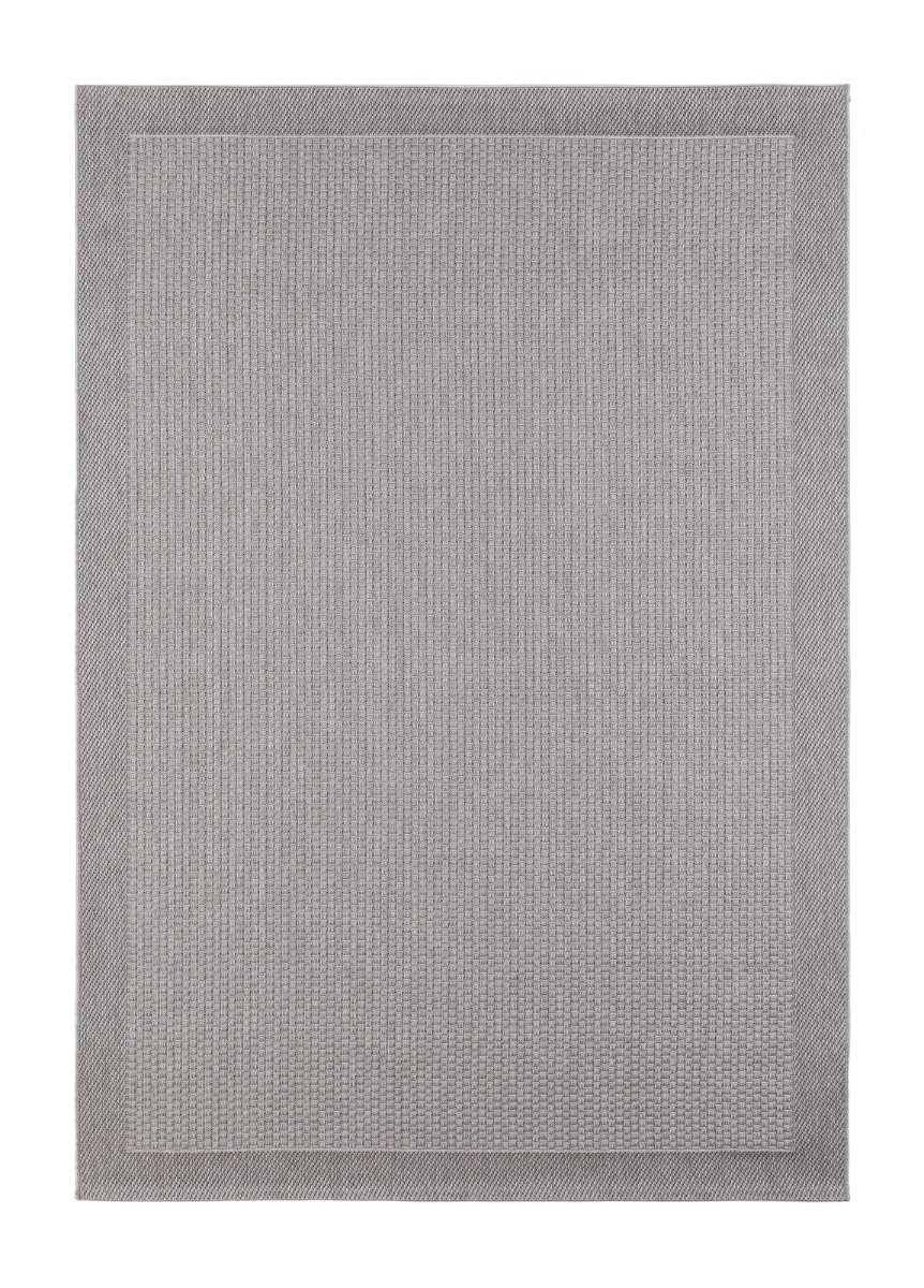 Costa grå flatvävd matta i polypropylen placerad inomhus på ett trägolv